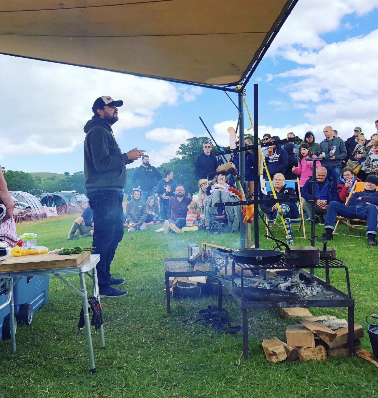 Michael Basco giving a live open-fire cooking demonstration to a festival audience